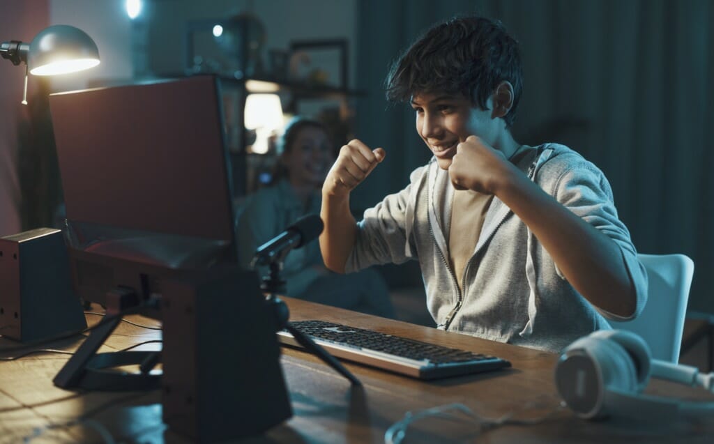 Happy teenager celebrating after winning puzzle game