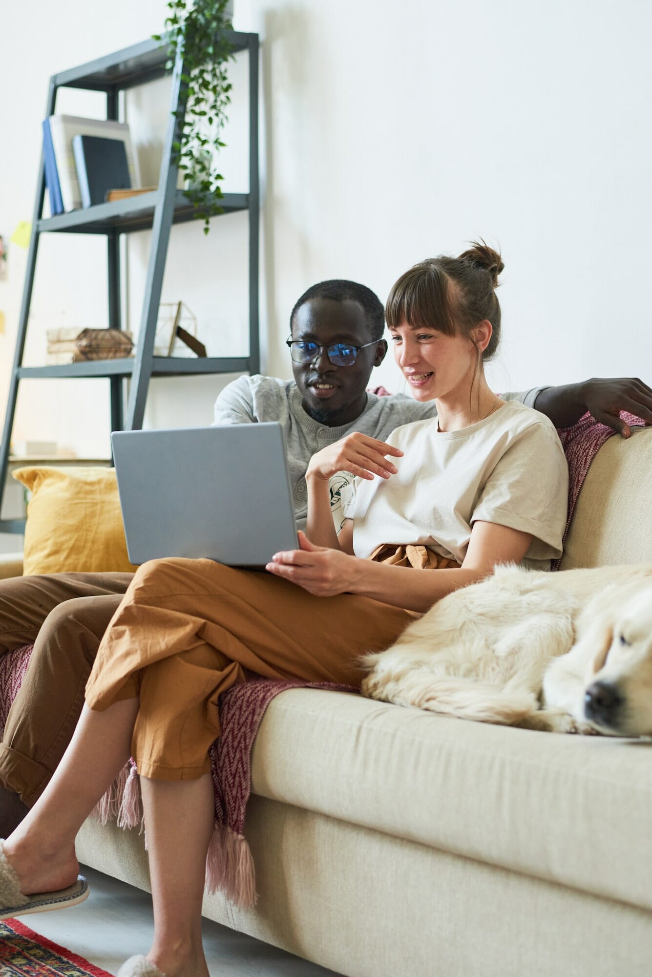 Young couple using laptop at home