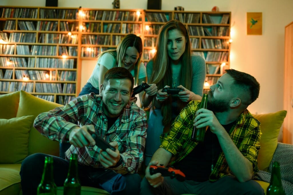 A group of friends playing video games while relaxing at home