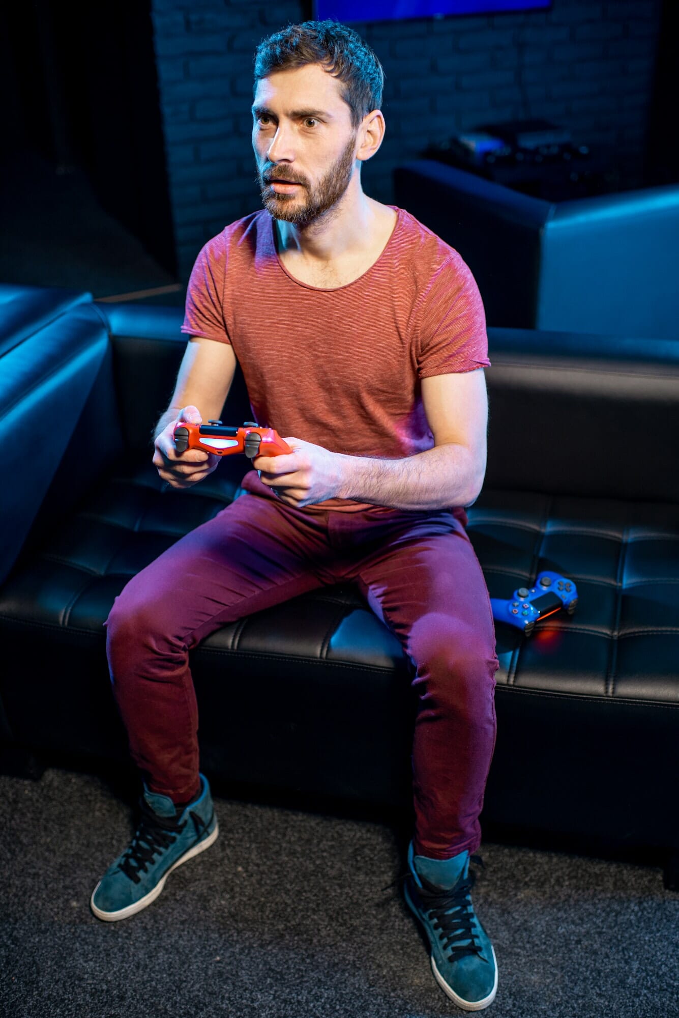 Man playing video games with gaming console in the club, Life Simulation Games Development Agency