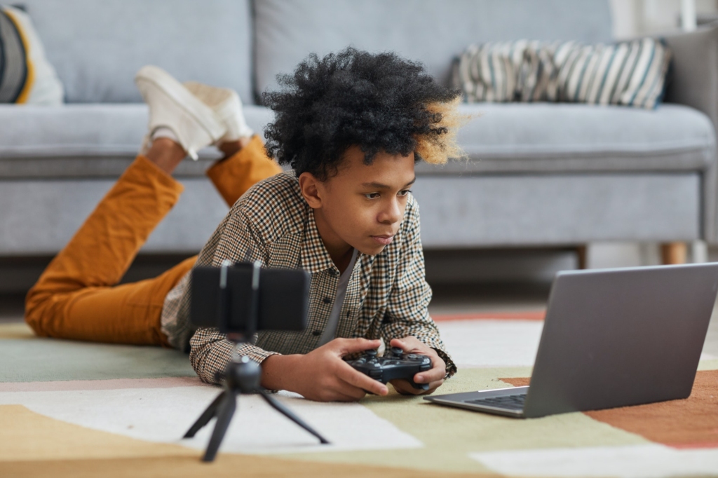 African-American Boy Playing Videogames on Floor