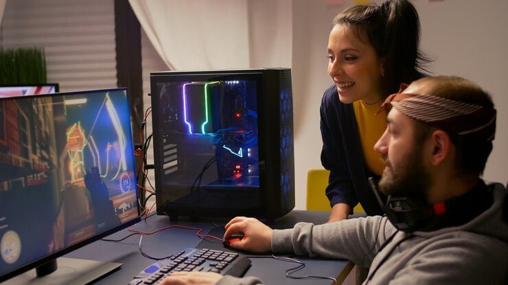 Pro gamer playing on a high-end PC while a girl watches his gaming skills