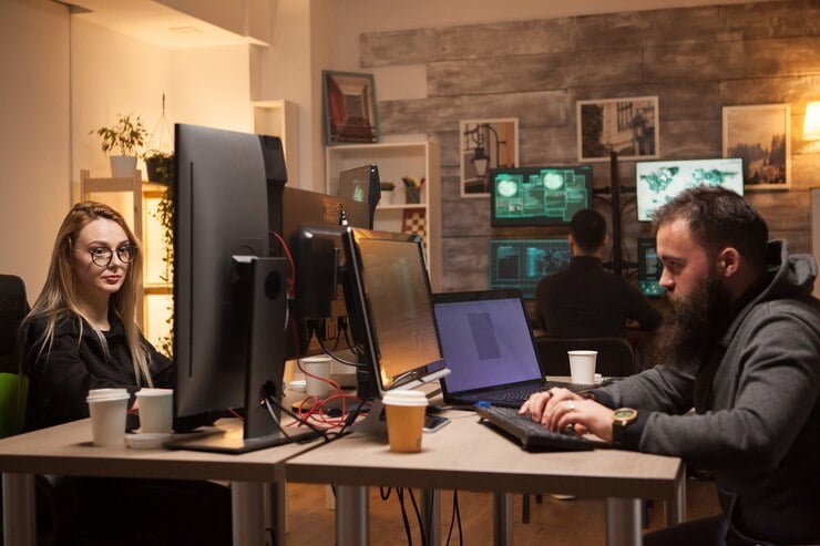 Bearded man playing a 3D game on a desktop