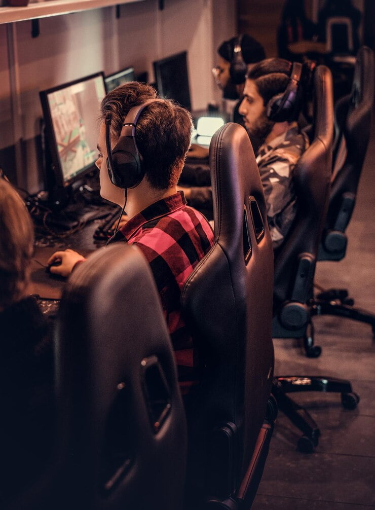 Pro gamers playing 3D games in a gaming room