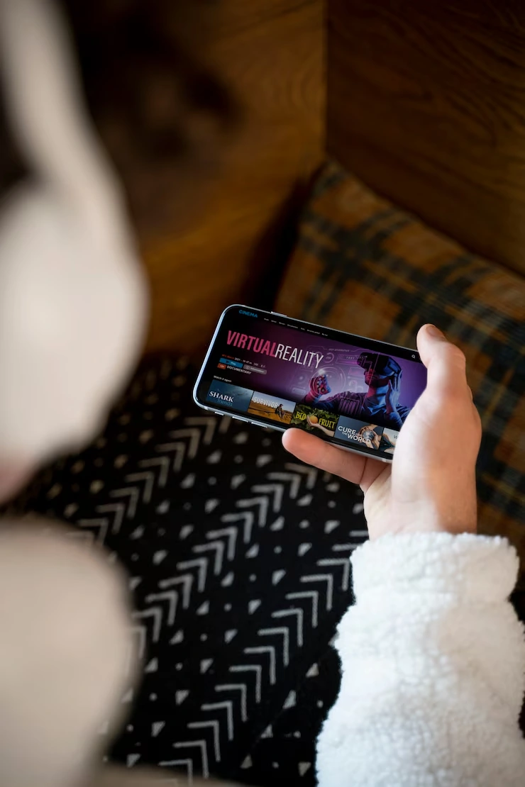 Mobile Game Development for IOS Mobile Game Development for iOS Devices User interacting with a virtual reality game on an iPhone