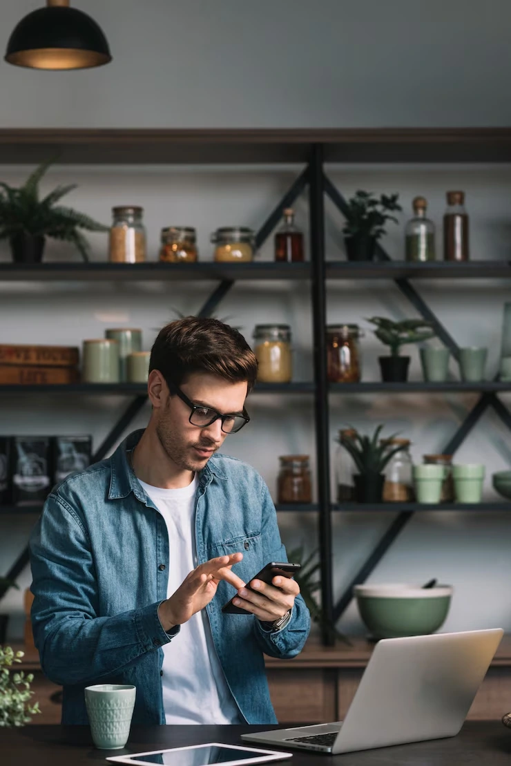 Mobile Game Development for iOS Devices User checking their smartphone while working in a modern office environment.