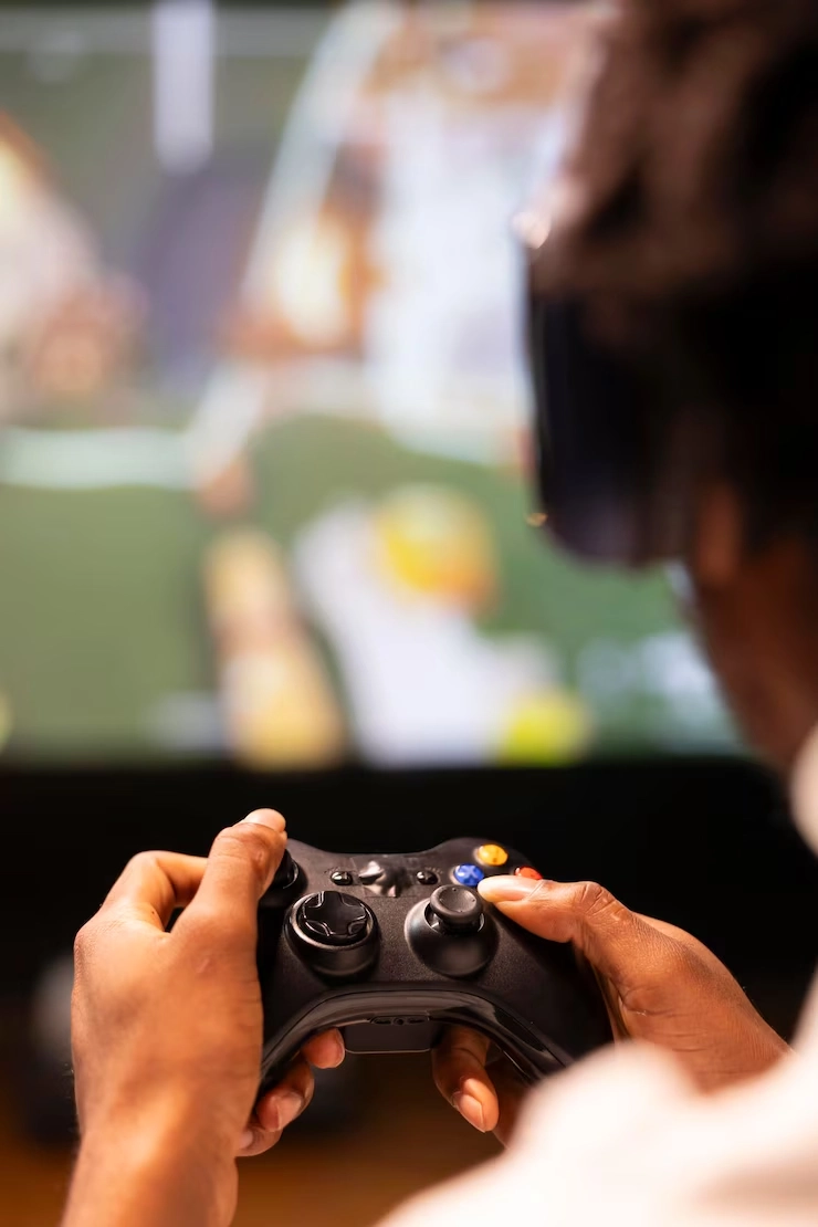 Gamer using joystick during session by Game Development Agency in UAE