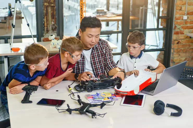 Educational Game Development Agency team guiding kids with robotic car project