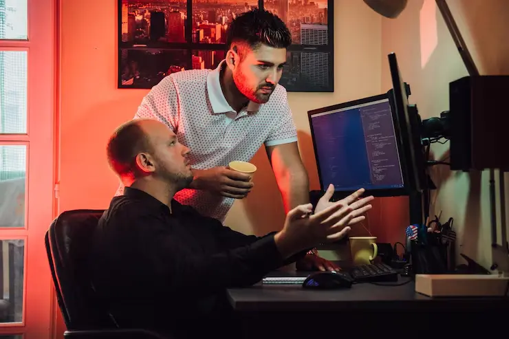 Developers analyzing screen for Unreal Engine Game Development Agency tasks