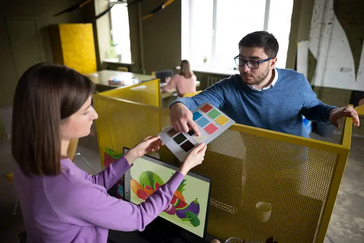 Multiplayer Game Development Multiplayer Game Development Agency collaborating on color palette choices at a workstation