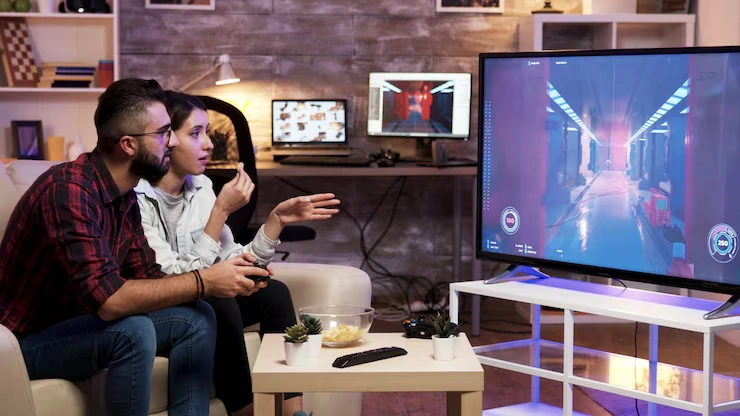 Multiplayer Game Development Multiplayer Game Development Agency couple focused on gameplay in a modern living room
