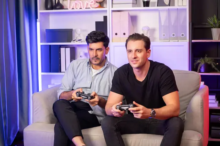 Multiplayer Game Development Multiplayer Game Development Agency team playing on console for gameplay feedback