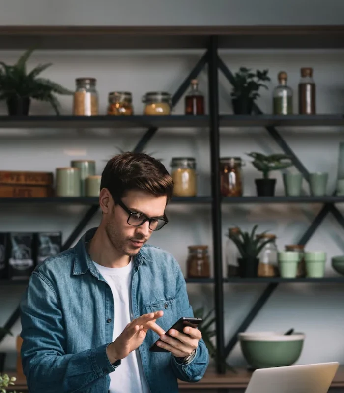Individual interacting with a mobile game on a smartphone, showcasing mobile game development for iPad games.