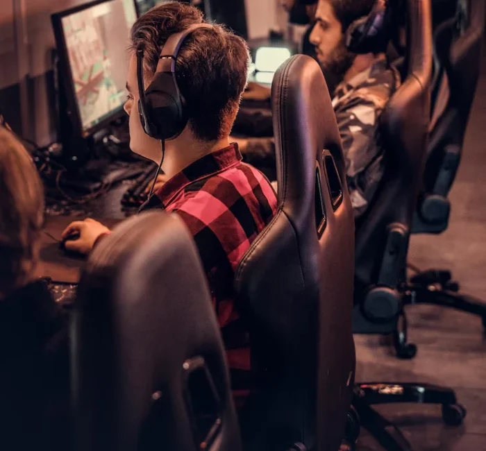 Gamers playing interactive iPad games at a gaming station, showcasing the immersive experience of mobile game development.