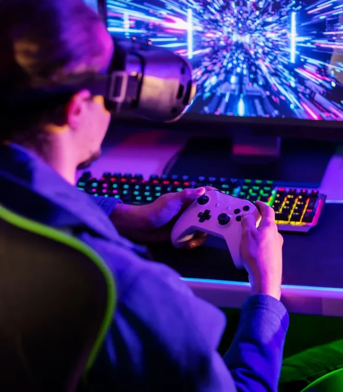 Gamer experiencing immersive gameplay with a VR headset and game controller, showcasing advanced game development.