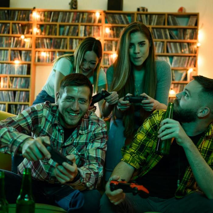 A group of friends playing video games while relaxing at home