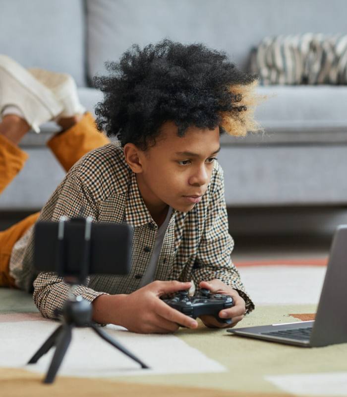 African-American Boy Playing Videogames on Floor