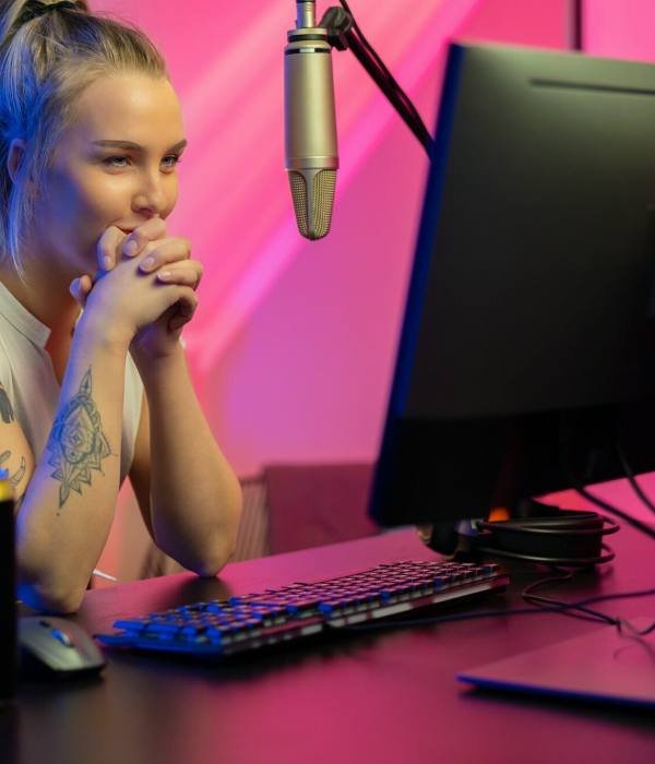 A Roblox game developer, a girl, intently looking at her computer screen