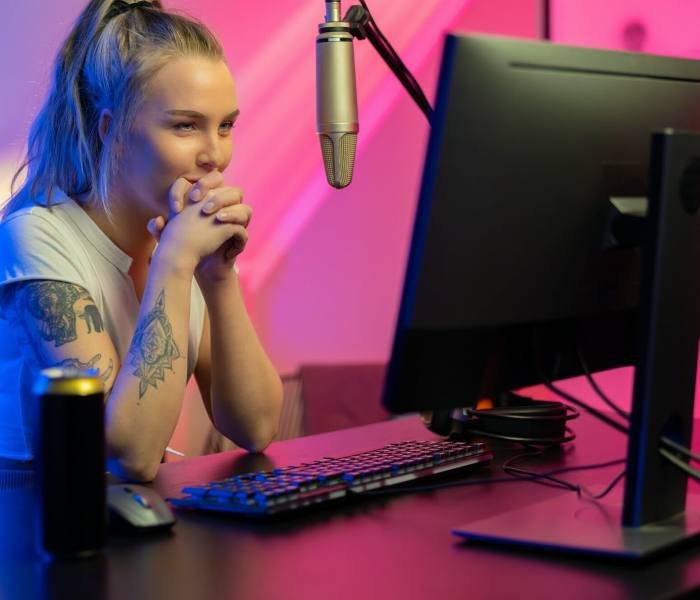 A Roblox game developer, a girl, intently looking at her computer screen