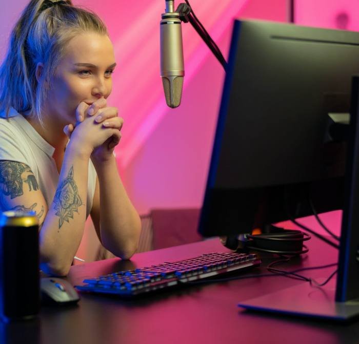 A Roblox game developer, a girl, intently looking at her computer screen