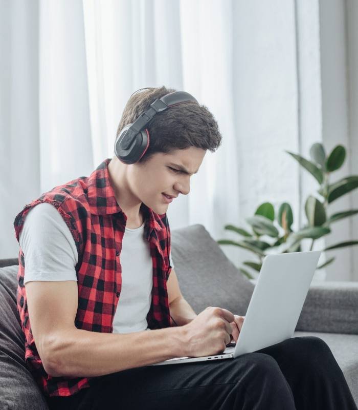 a boy playing game on laptop