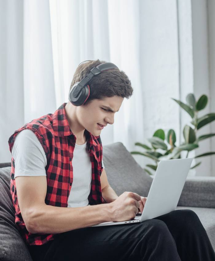 a boy playing game on laptop