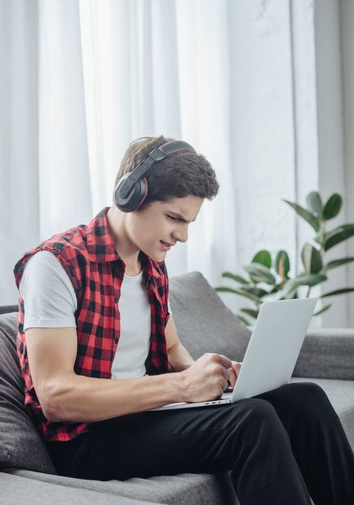 a boy playing game on laptop