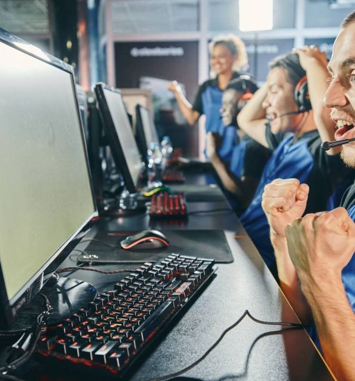 Excited professional gamers celebrating success while playing