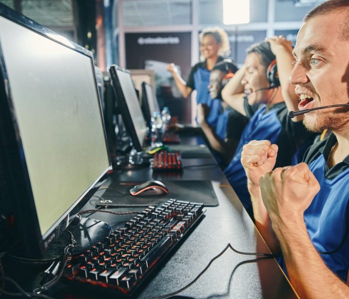 Gaming Team Celebration Moment Multiracial esports team cheering in game studio