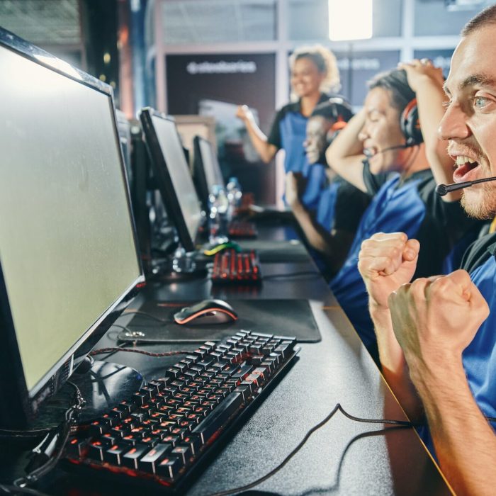 Multiracial esports team cheering in game studio