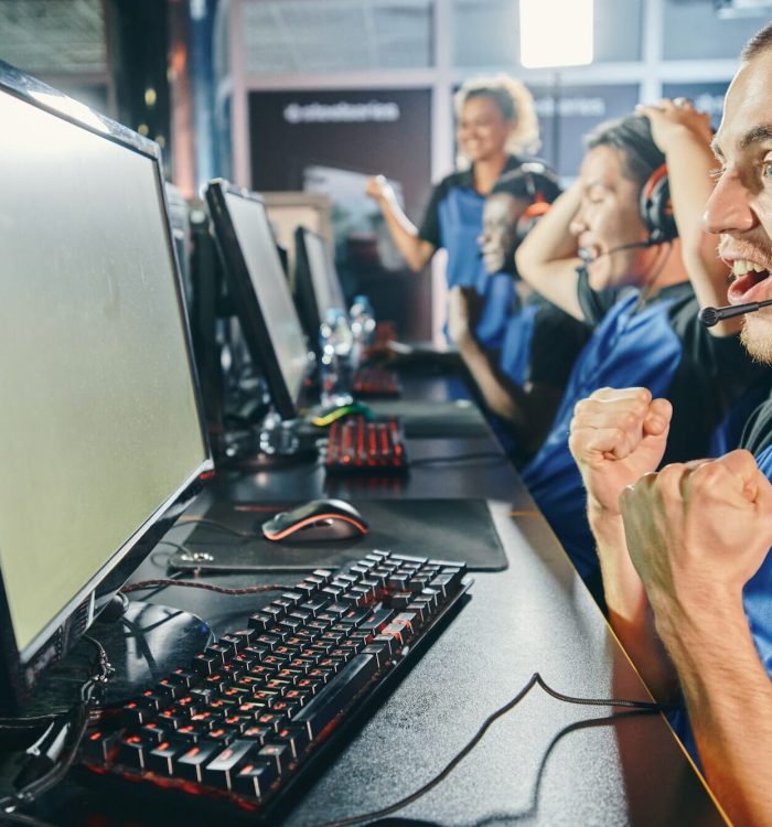 Multiracial esports team cheering in game studio
