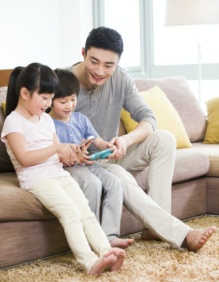 Father and kids playing video game