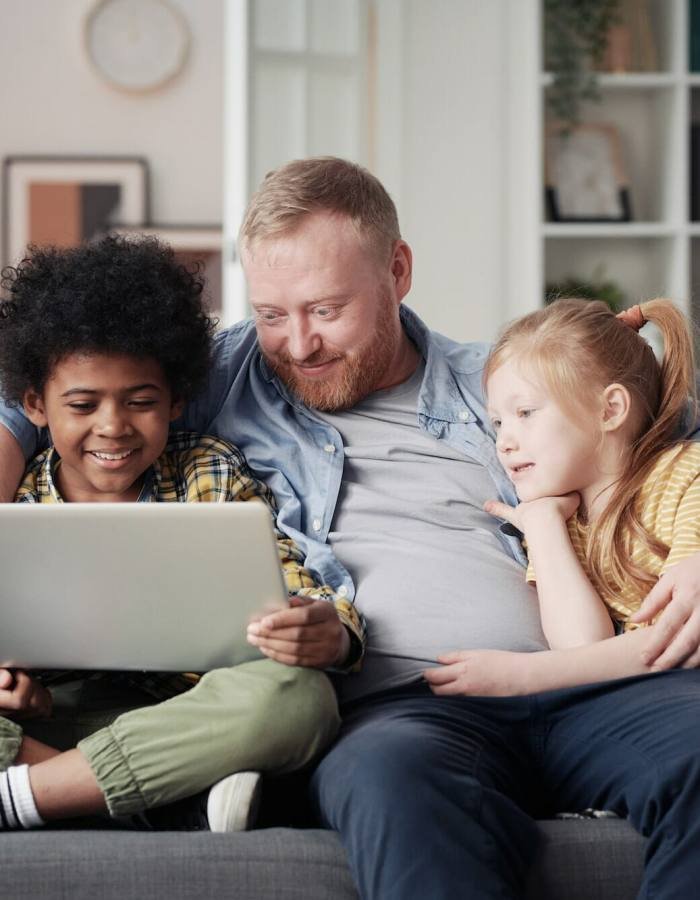 Father with children using laptop at home, Roblox Development Studio