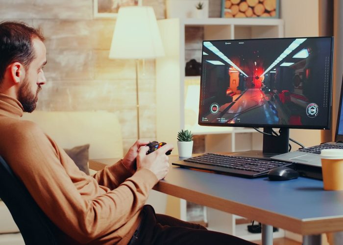 Game developer testing new joystick for shooter game