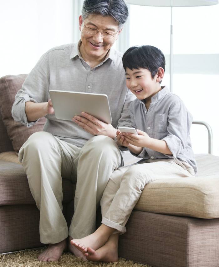 Happy grandfather and grandson with digital tablet and smart phone, Unity Game Development for Android