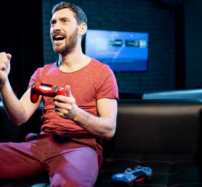 Happy man playing video games with gaming console in the club, Mobile Game Development for Android