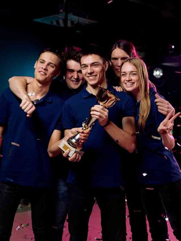 Gaming team celebrating victory, representing indie game development success in London.