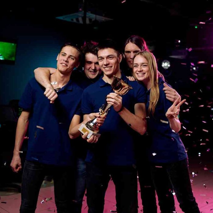 Gaming team celebrating victory, representing indie game development success in London.