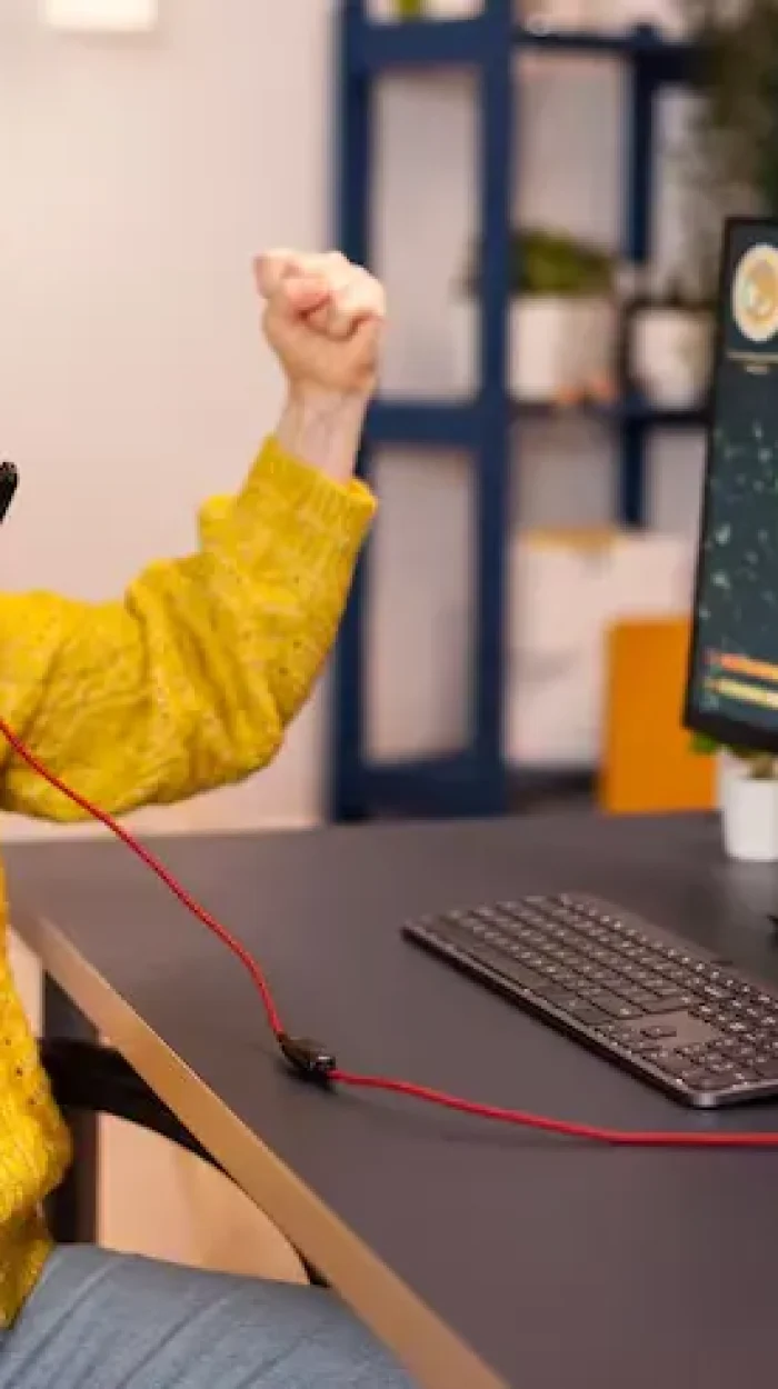 joyful-player-celebrates-victory-winning-space-shooter-online-video-game-powerful-personal-computer_482257-2061