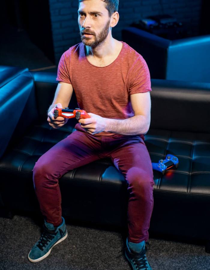 Man playing video games with gaming console in the club, Life Simulation Games Development Agency