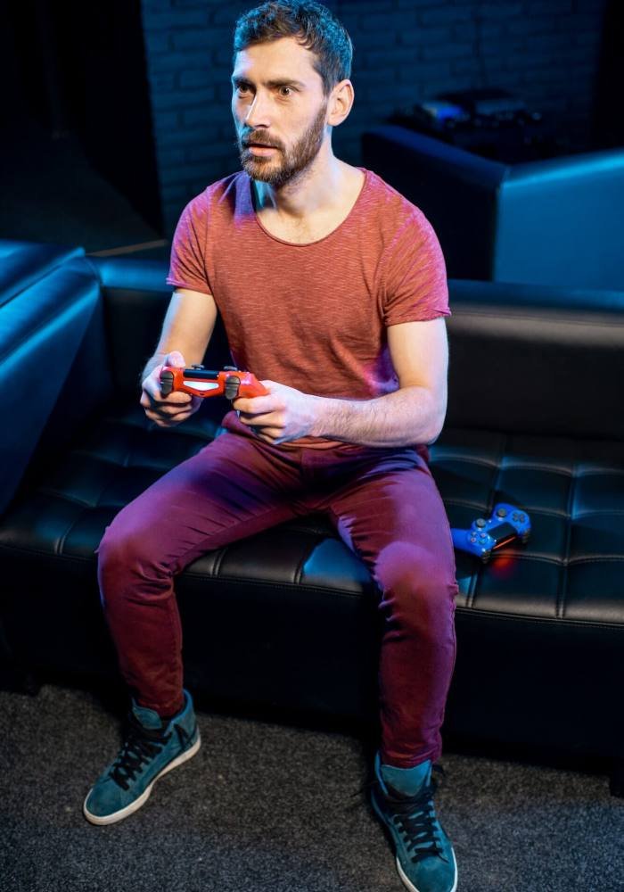 Man playing video games with gaming console in the club, Life Simulation Games Development Agency