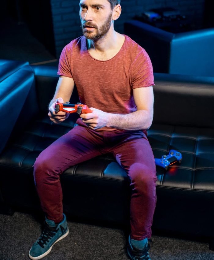 Man playing video games with gaming console in the club, Life Simulation Games Development Agency