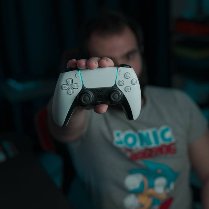 A man holding a joystick in his hand, ready for gaming or game development.