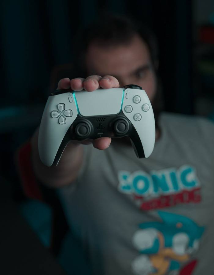 A man holding a joystick in his hand, ready for gaming or game development.