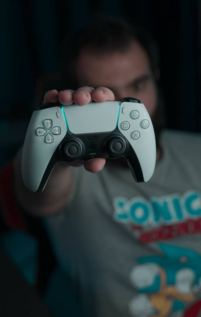 A man holding a joystick in his hand, ready for gaming or game development.