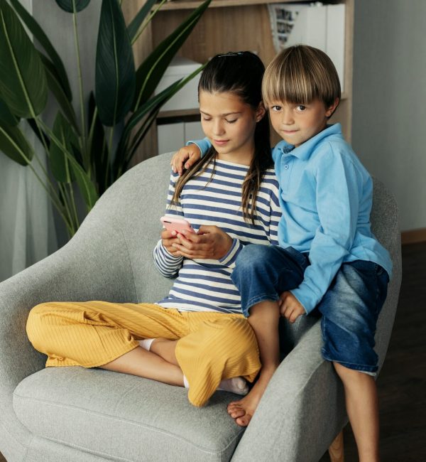 Children playing mobile games at home