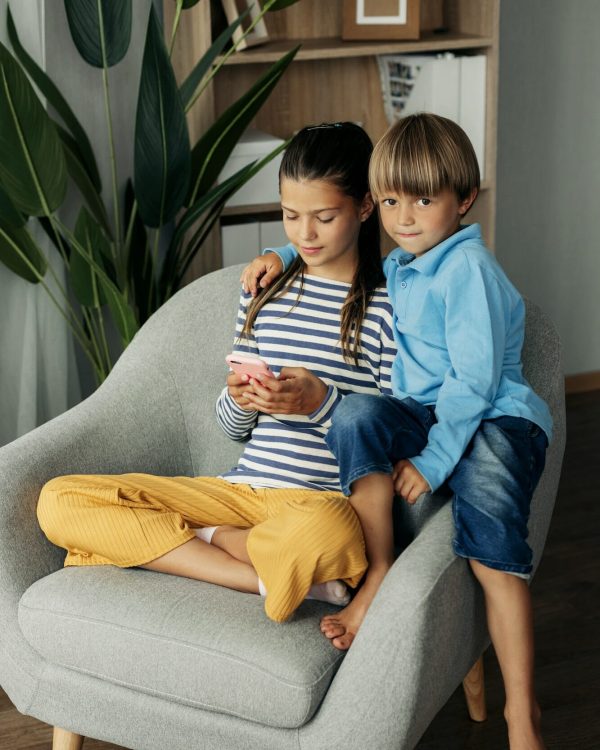 Children playing mobile games at home