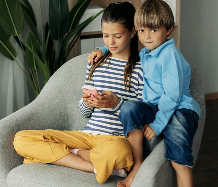 Children playing mobile games at home
