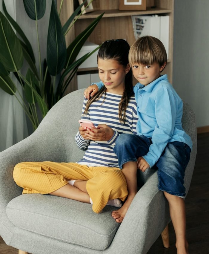 Children playing mobile games at home
