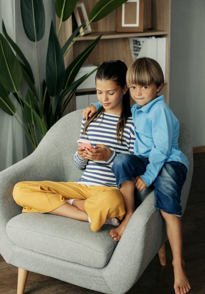 Children playing mobile games at home